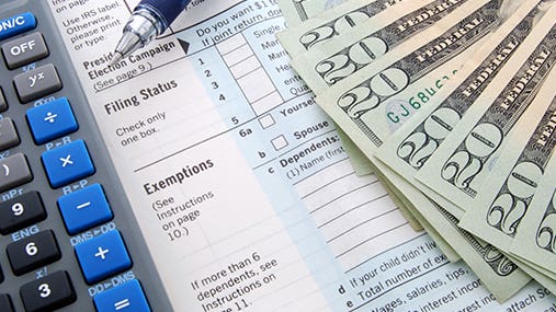 Form 1040 focused on exemptions section and calculator © Kimberly Reinick - Fotolia.com