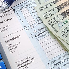 Form 1040 focused on exemptions section and calculator © Kimberly Reinick - Fotolia.com