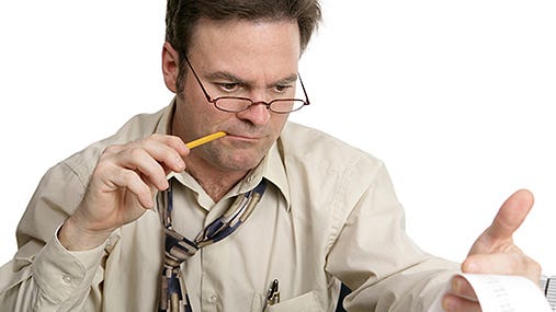 Man doing taxes, pencil in mouth © Fotolia.com