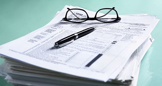 Large stack of tax forms © OtnaYdur/Shutterstock.com