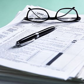 Large stack of tax forms © OtnaYdur/Shutterstock.com