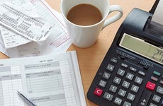 Receipts with bookkeeping ledger and calculator © RTimages / Fotolia