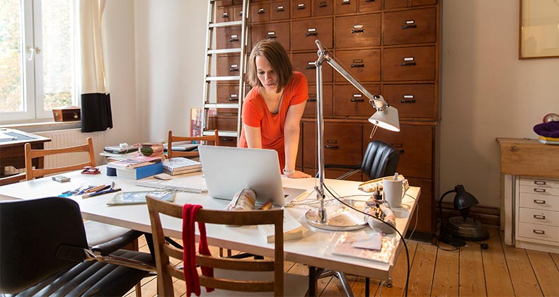 Woman working in home office | Simon Ritzmann/Getty Images