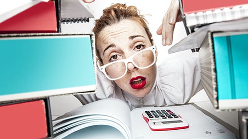 Secretary or accountant stressed at paperwork © ndphoto/Shutterstock.com