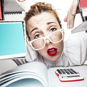 Secretary or accountant stressed at paperwork © ndphoto/Shutterstock.com