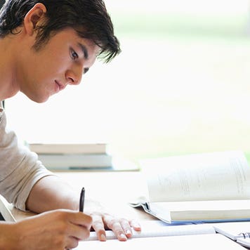 Young man writing at desk © wavebreakmedia/Shutterstock.com