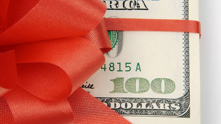 $100 wrapped in red ribbon © Andy Dean Photography/Shutterstock.com
