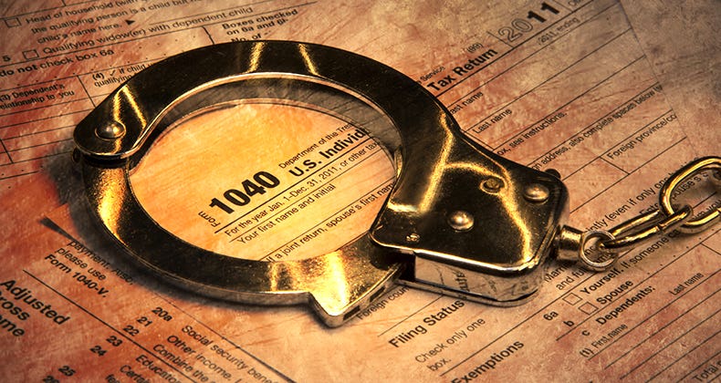 Handcuffs on tax form © PTstock/Shutterstock.com