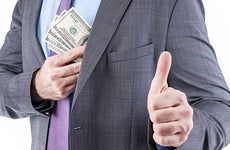 man in suit receiving extra money ©Drazen/Shutterstock.com