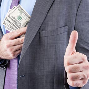 man in suit receiving extra money ©Drazen/Shutterstock.com