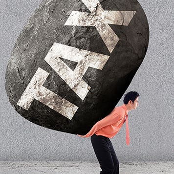 Stressed man carring a big rock of tax on his back © Creativa Images/Shutterstock.com