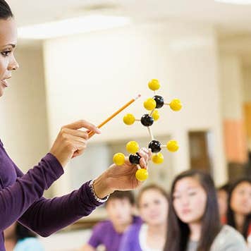 Science teacher in class | Jon Feingersh/Getty Images