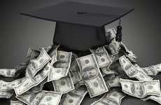 Graduation cap on top of pile of money
