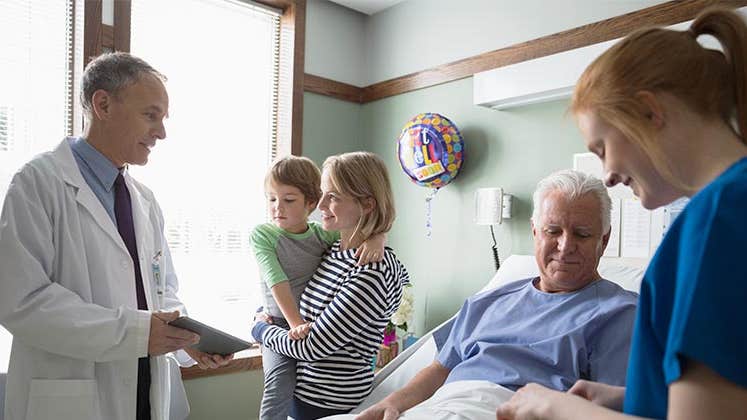 Doctor talking to patient's family | Hero Images/Getty Images