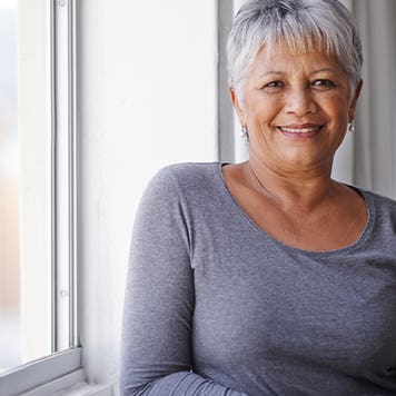 Woman posing by window © iStock