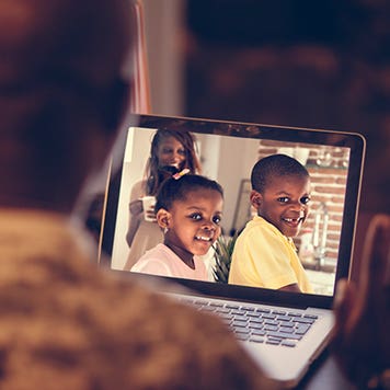 Man talking to family on his computer