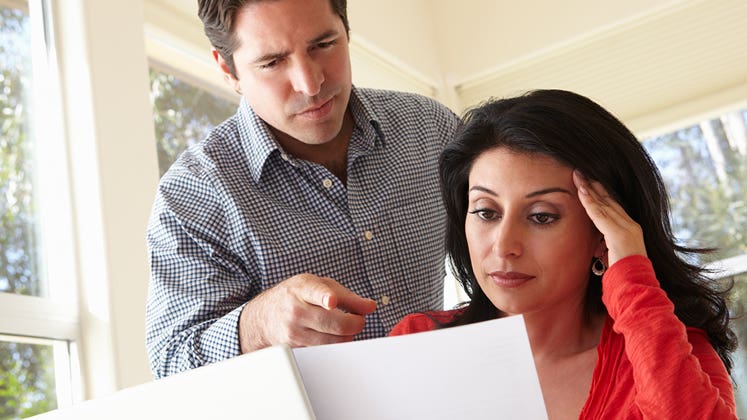 Husband and wife looking over documents © iStock