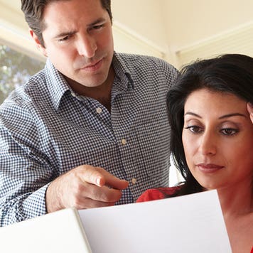 Husband and wife looking over documents © iStock