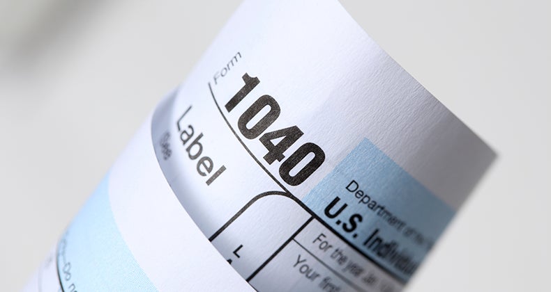 Rolled tax form 1040 © iStock