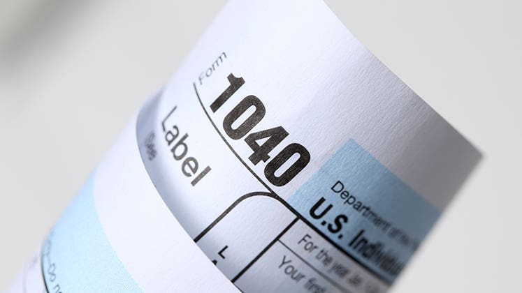 Rolled tax form 1040 © iStock