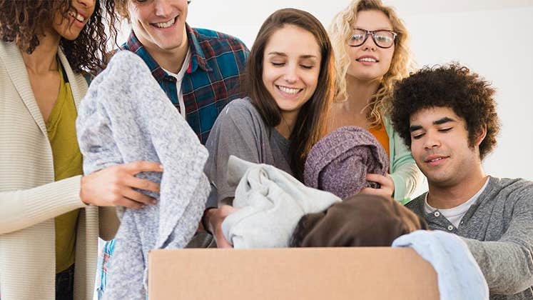 Millennials dropping off clothes to a donation outbox | JGI/Jamie Grill/Getty Images