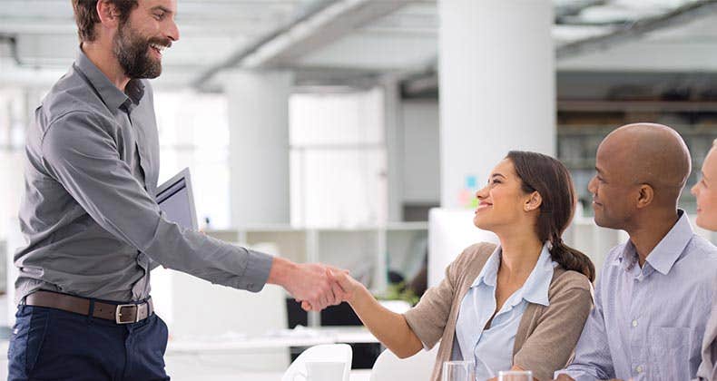 Employees shaking hands | PeopleImages.com/Getty Images