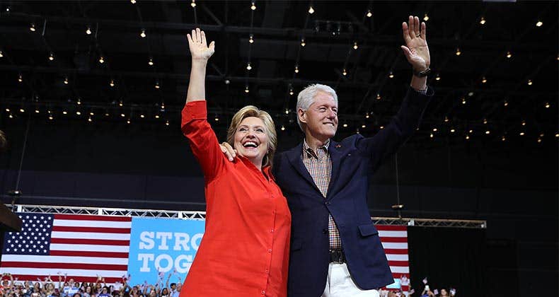 Hillary and Bill Clinton waving | Justin Sullivan/Getty Images