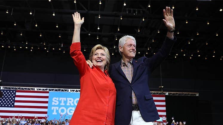 Hillary and Bill Clinton waving | Justin Sullivan/Getty Images