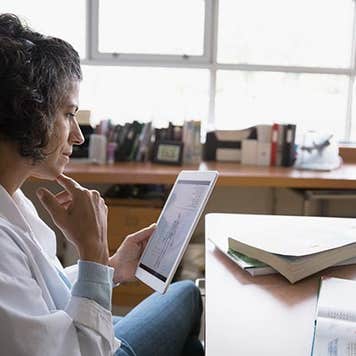 Woman looking at medical tablet | Hero Images/Getty Images