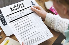 Woman reviewing credit report dispute form