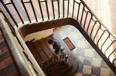 Man walking up spiral staircase