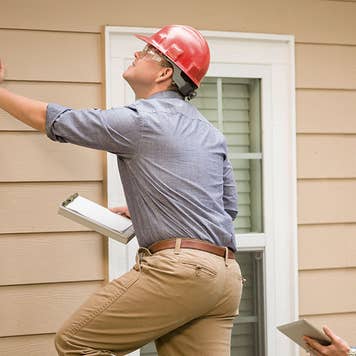 Two home appraisers examining a house