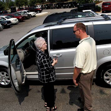 Woman and man talking at a car lot
