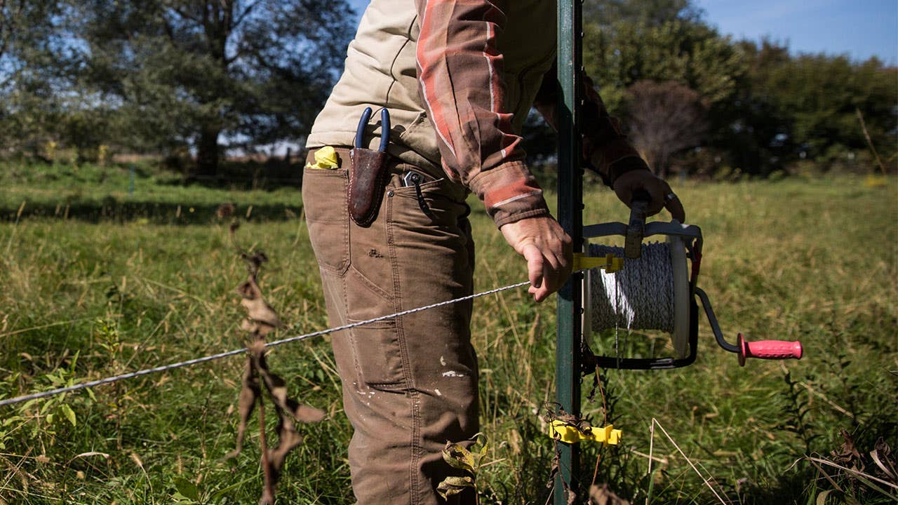 Man installing an electric fence