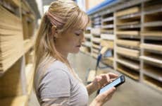 Woman in a hardware store using an app