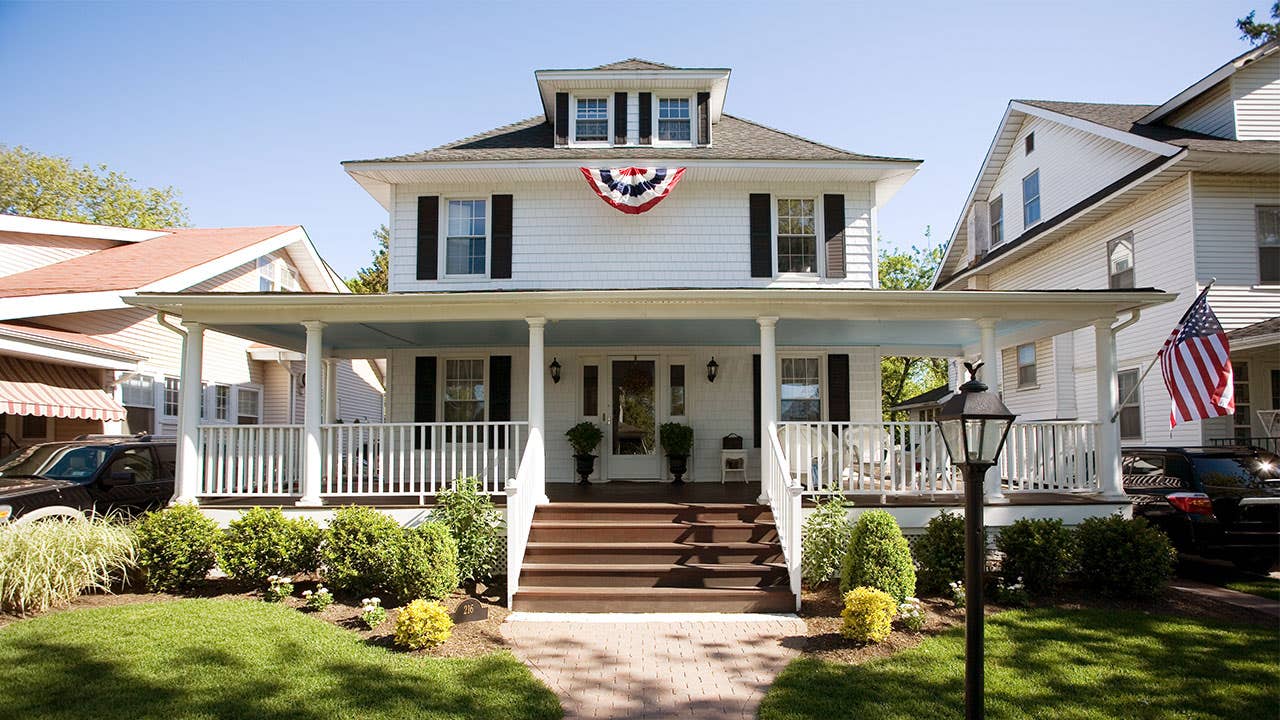 Colonial-style house with flags hanging | Nine OK/Getty Images