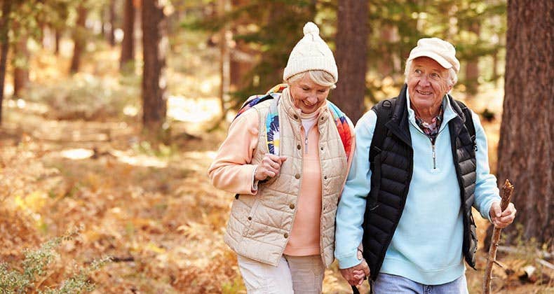 Senior couple hiking in the woods | Monkey Business Images/Shutterstock.com