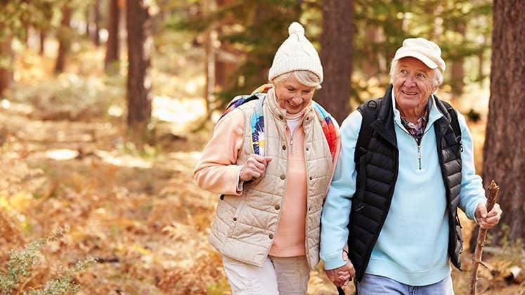Senior couple hiking in the woods | Monkey Business Images/Shutterstock.com