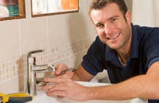 Young man fixing faucet © iStockPhoto.com