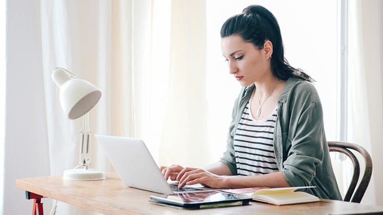 Woman working in her home office © iStock