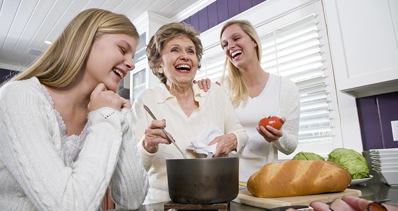 Adult children cooking dinner with their mother © Golden Pixels LLC/Shutterstock.com