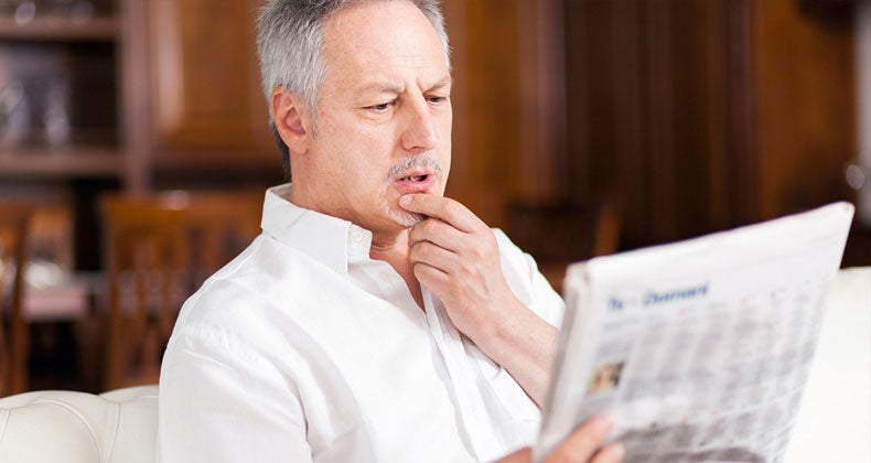 Man reading newspaper © iStock