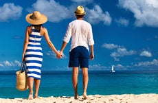 Couple holding hands on the beach © iStock