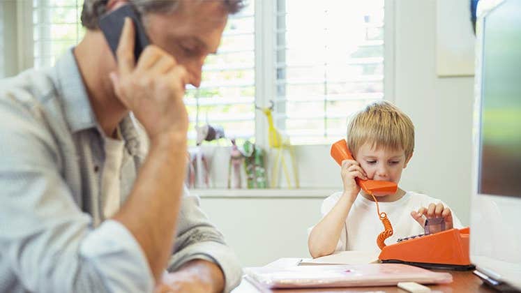 Toddler playing with toy phone | Paul Bradbury/Getty Images