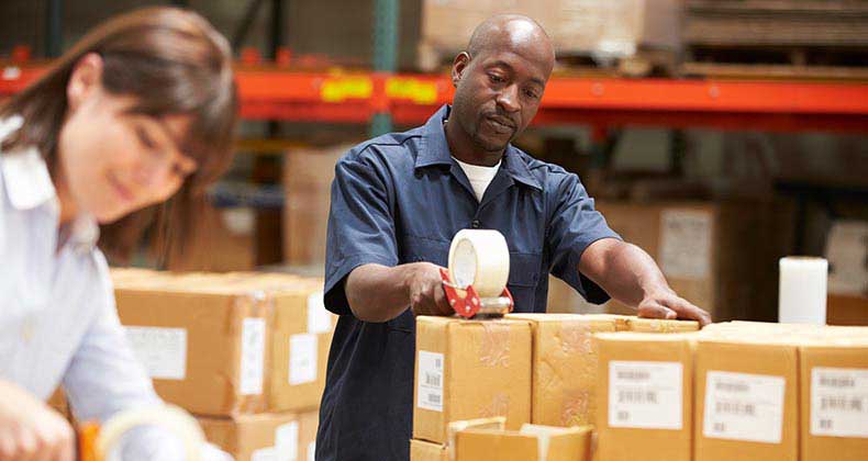 Two workers preparing shipment in warehouse | Monkey Business Images/Shutterstock.com