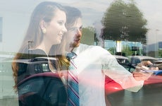 Salesman showing car from window © iStock