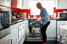 Woman loading dishwasher © iStock