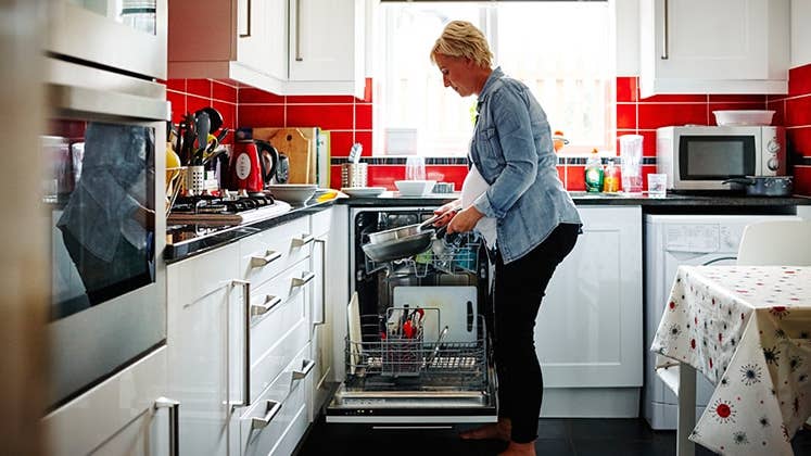 Woman loading dishwasher © iStock