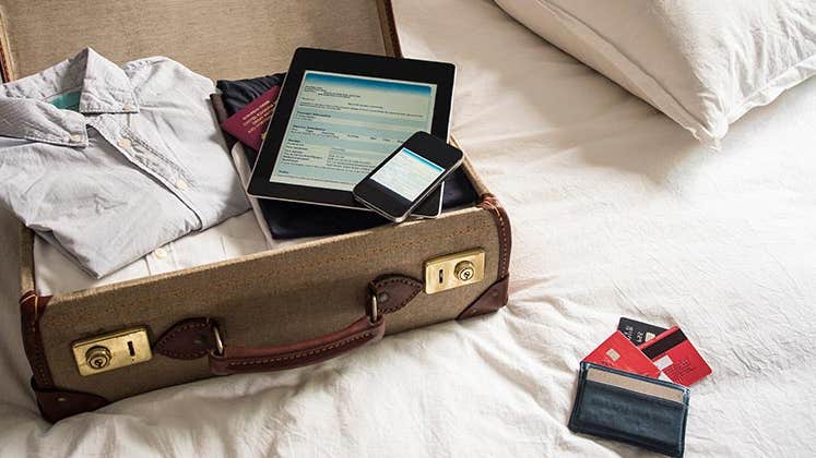 Packing suitcase for a trip | David Cleveland/Getty Images
