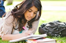 Young woman studying on grass © arek_malang/Shutterstock.com